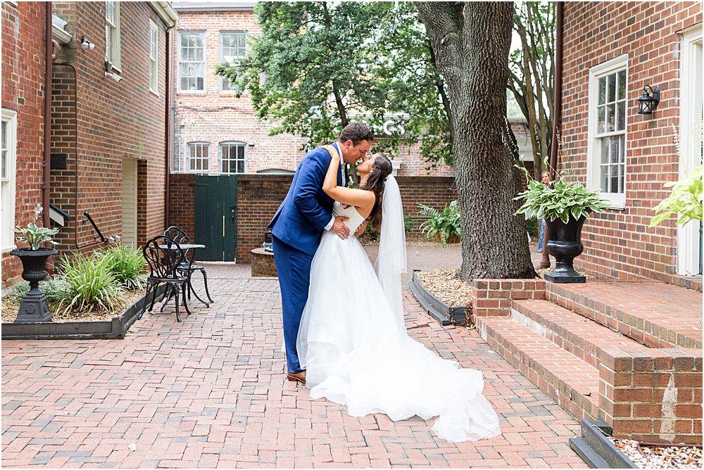 Bride and groom share kiss before classic southern wedding ceremony