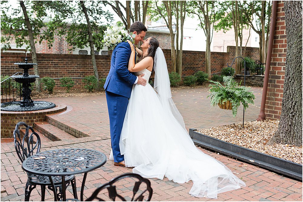 bride and groom, nose to nose, before their classic southern wedding