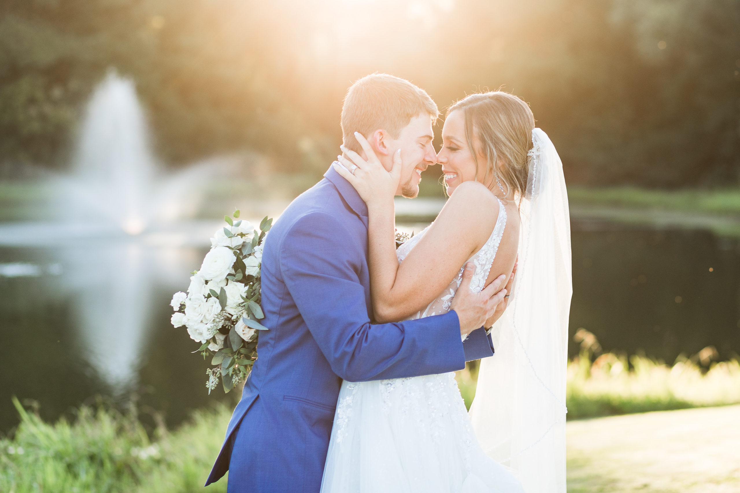 Bride and groom gaze lovingly at one another during golden hour, nose to nose