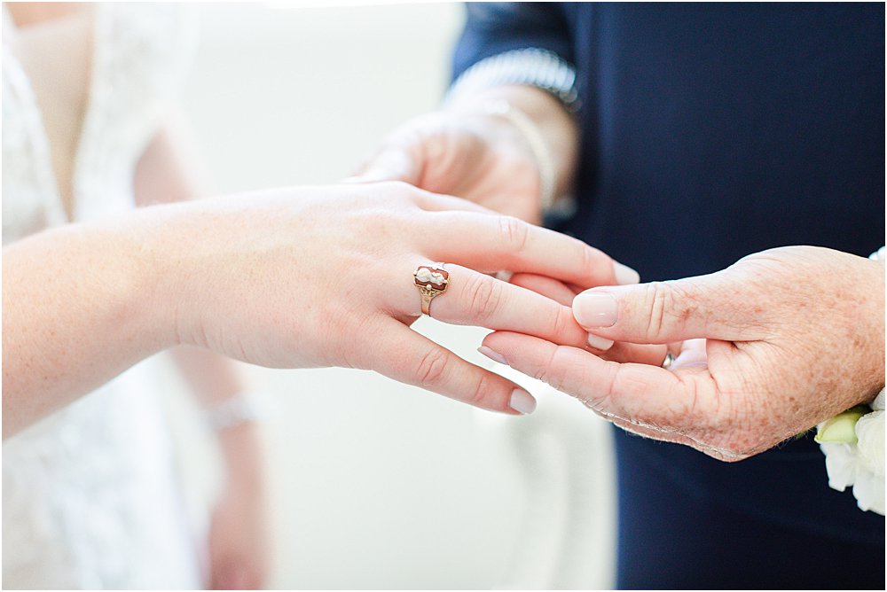 A father holds his daughter's hand, clad with antique ring on her stress free wedding day
