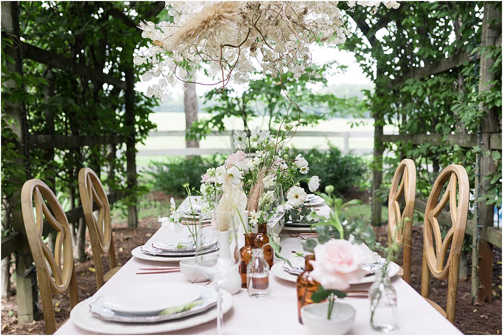 Elegant stress free wedding tables cape under greenery covered arbor