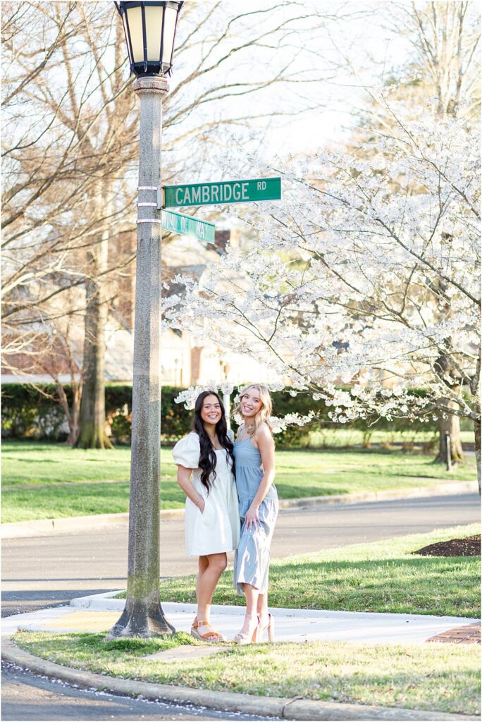 Keira and Ellen stand beneath the Cambridge Rd sign in the Windsor Farms neighborhood of Richmond VA during their spring senior portrait session