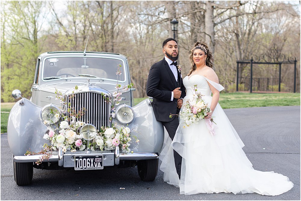 models pose in front of the car, parked at the front of the estate at river run during whimsical spring wedding editorial