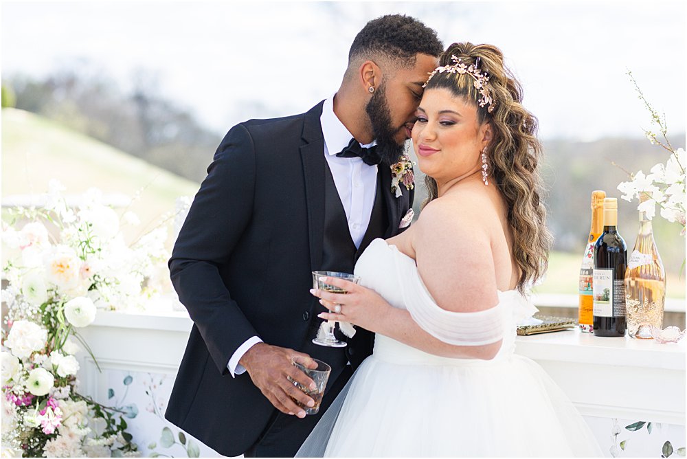 models enjoy signature cocktails and a snuggle during whimsical spring wedding editorial