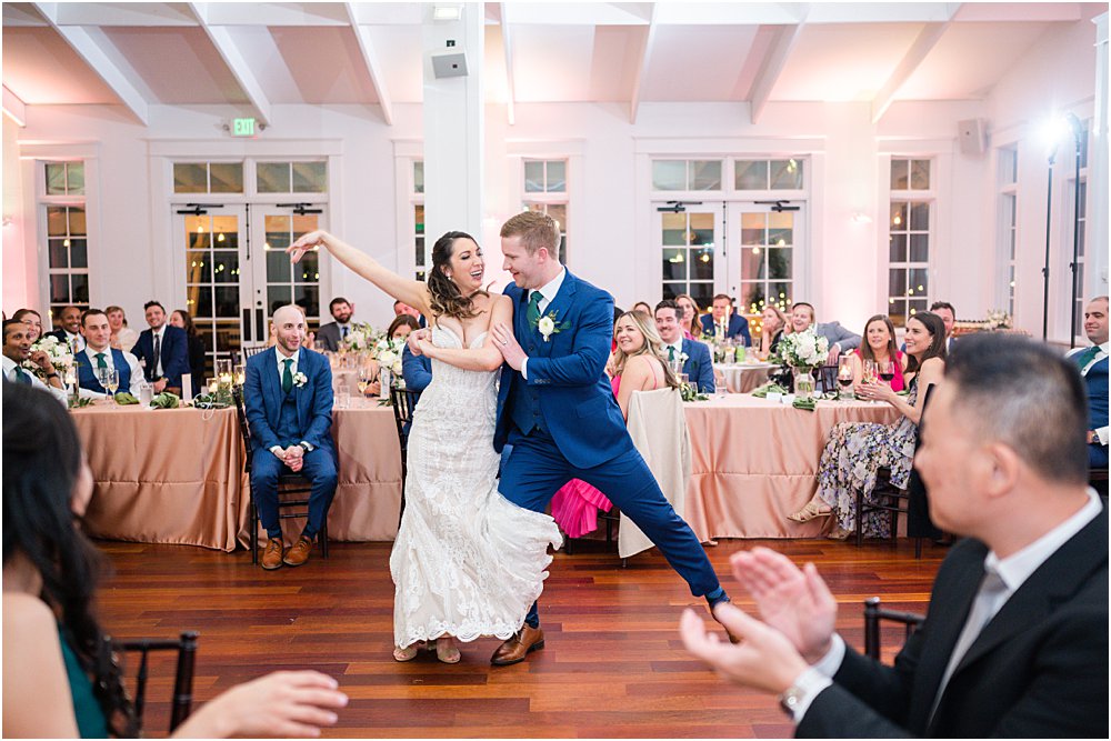 The bride and groom share a choreographed first dance at their modern romantic wedding reception.