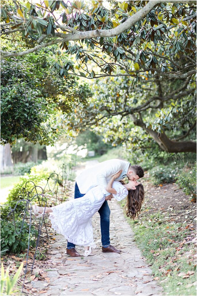 Dan dips Olivia for a spectacular movie-esque kiss on a path in Maymont Park during their effortlessly chic engagement session.