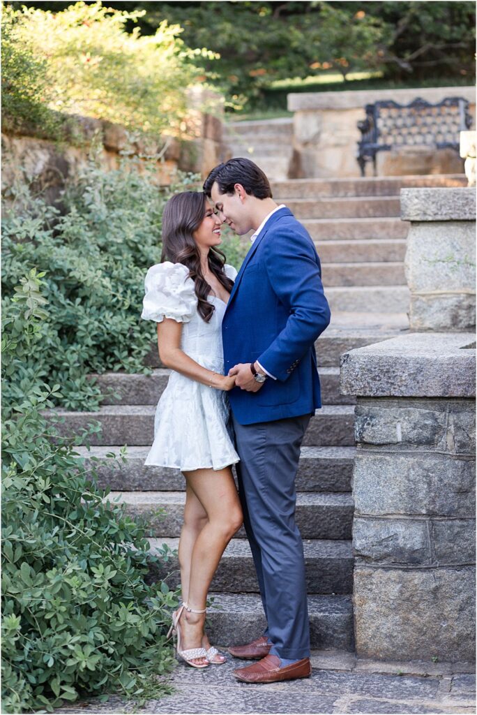 Gabriella smiles up at Raphael as his nose brushes against hers uring classic engagement session at Maymont Park in Richmond, VA.