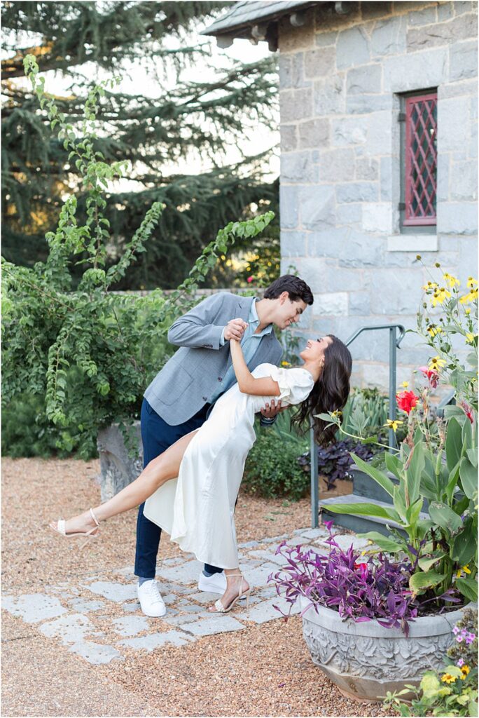 Raphael dips his bride to be. She laughs during classic engagement session at Maymont Park in Richmond, VA.