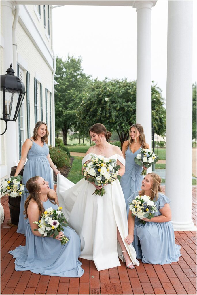 Estate at Independence outdoors with bride and bridesmaids wearing a floor length blue gown