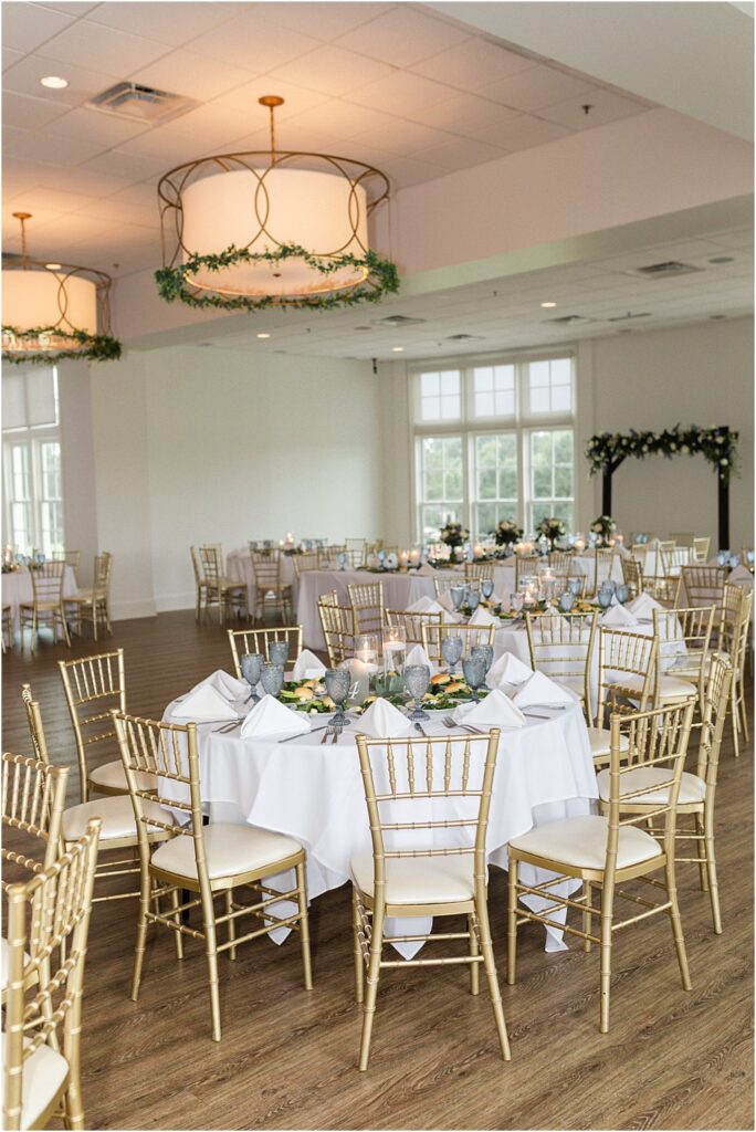 Estate at Independence ballroom with gold chairs and greenery set up for a formal dinner