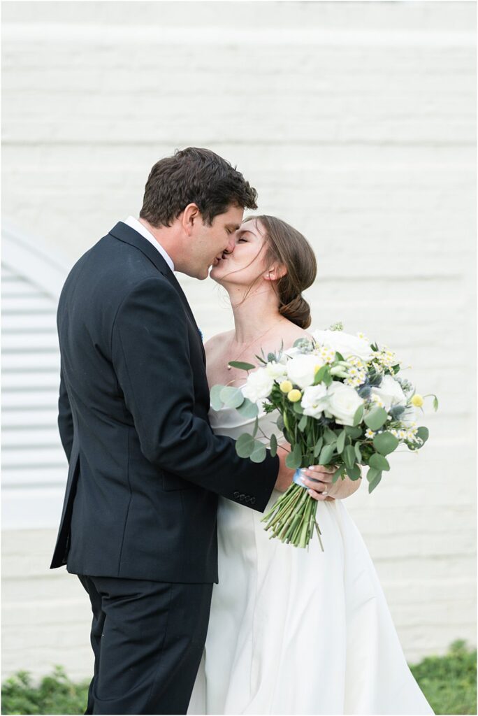 Estate at Independence bride and groom outdoors share a kiss during a first look