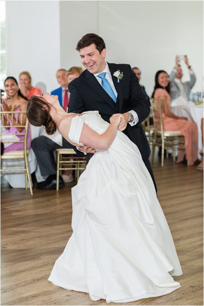 groom dips bride during the first dance