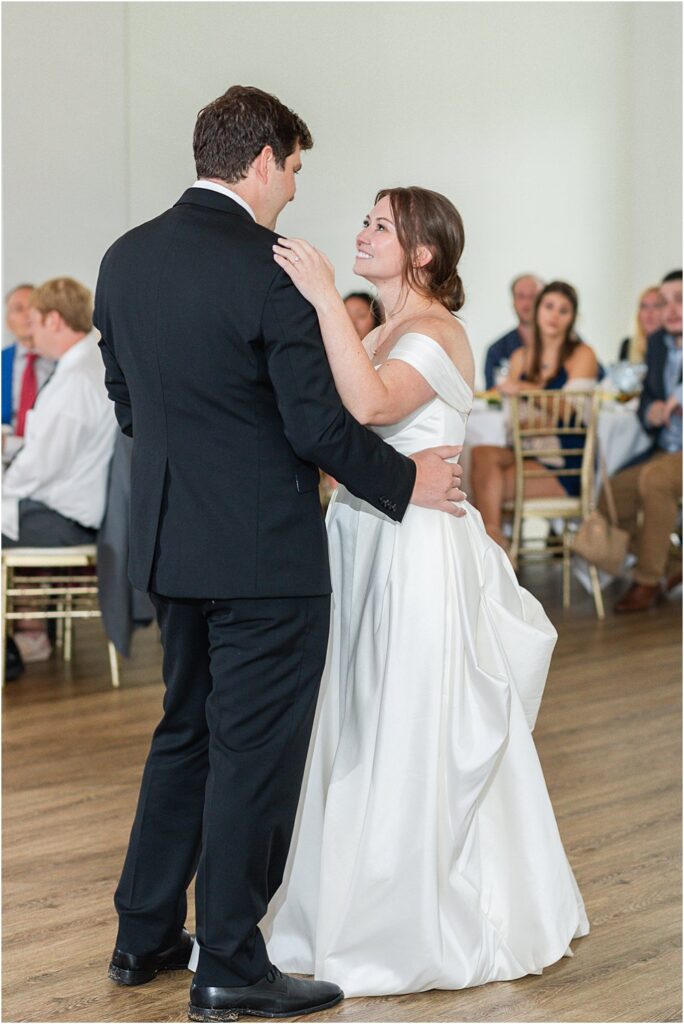 bride and groom share an intimate look during the first dance