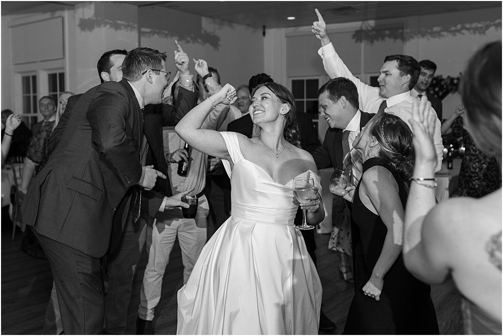 bride dancing on the dance floor while guests are cheering 