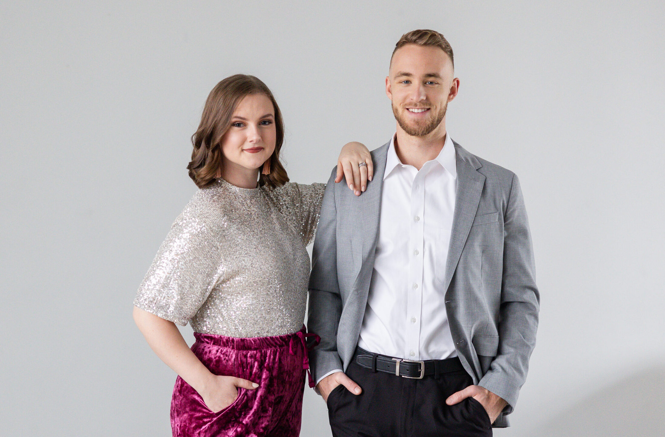 Couple standing together in a branded headshot session.