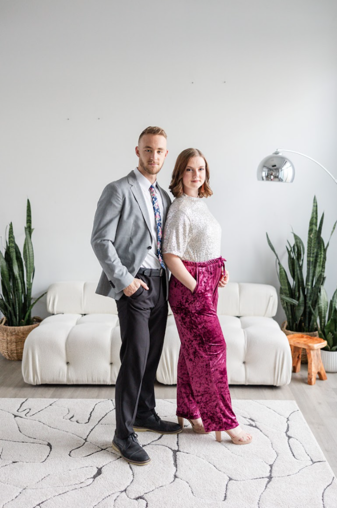 Couple standing side by side in a photo studio during a branded headshot session.