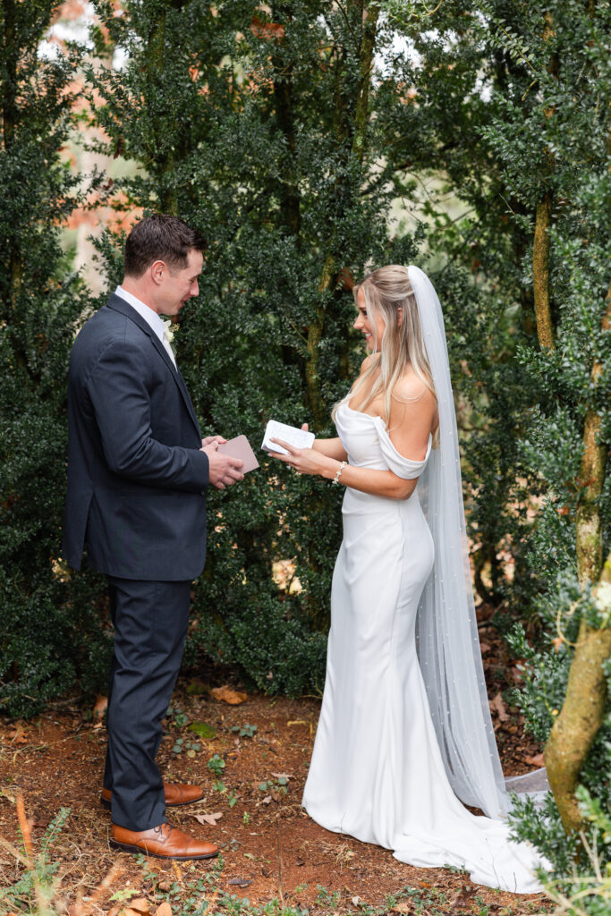 wedding couple reading private vows during a first look