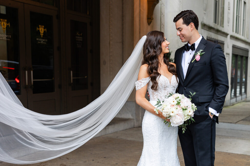 Wedding couple standing in front of John Marshall Hotel