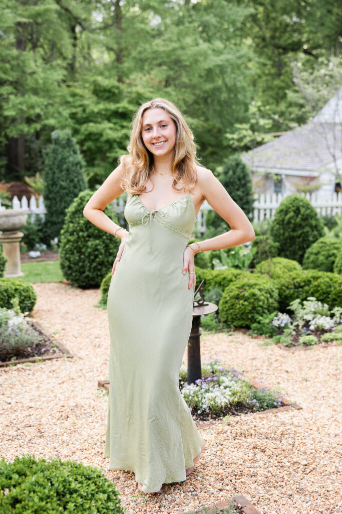 Nora wearing a green dress in the garden at Historic Tuckahoe for her Senior Portrait Session 