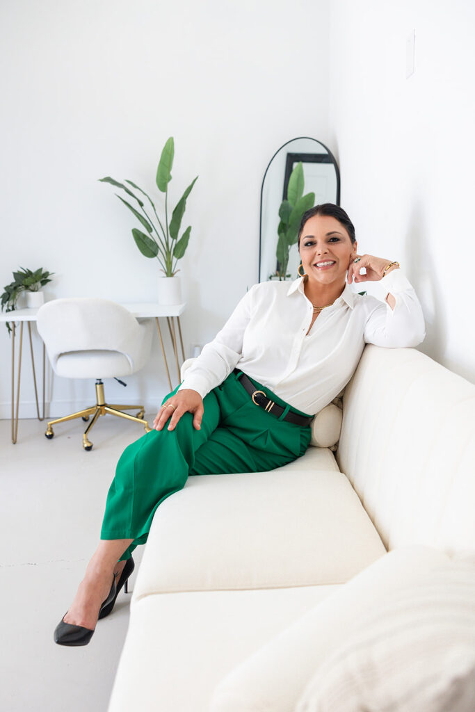 Realtor posing on couch during headshot session in Richmond VA