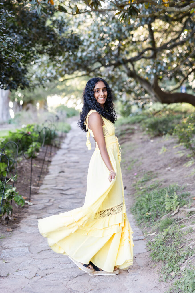 Girl twirling in yellow dress for senior portraits