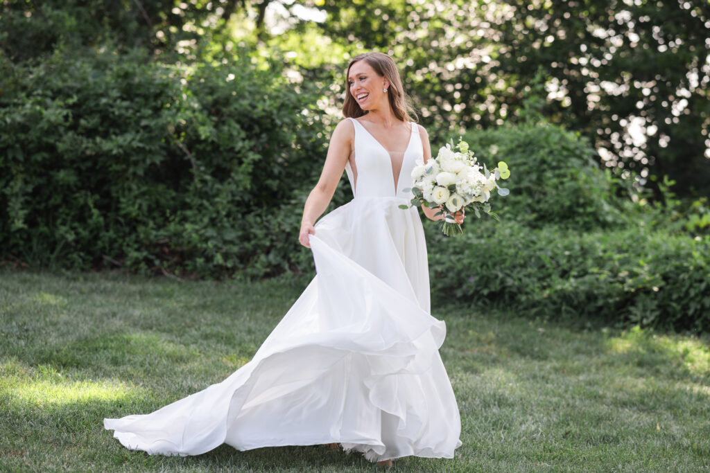 bride twirling her gown and laughing at upper shirley vineyards